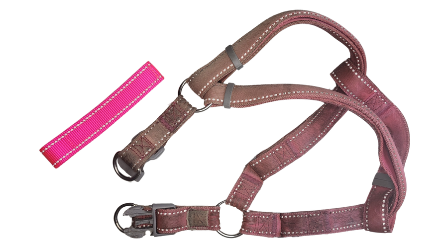 worn and dirty pink step in dog harness laying next to a sample of bright neon pink reflective webbing that a new custom dog harness will be made to match the old one.