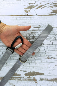 closeup of leash handle with d ring as well as auto locking carabiner.