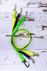 Adjustable leashes from reflective webbing are shown in a flat lay, featuring three hardware options.