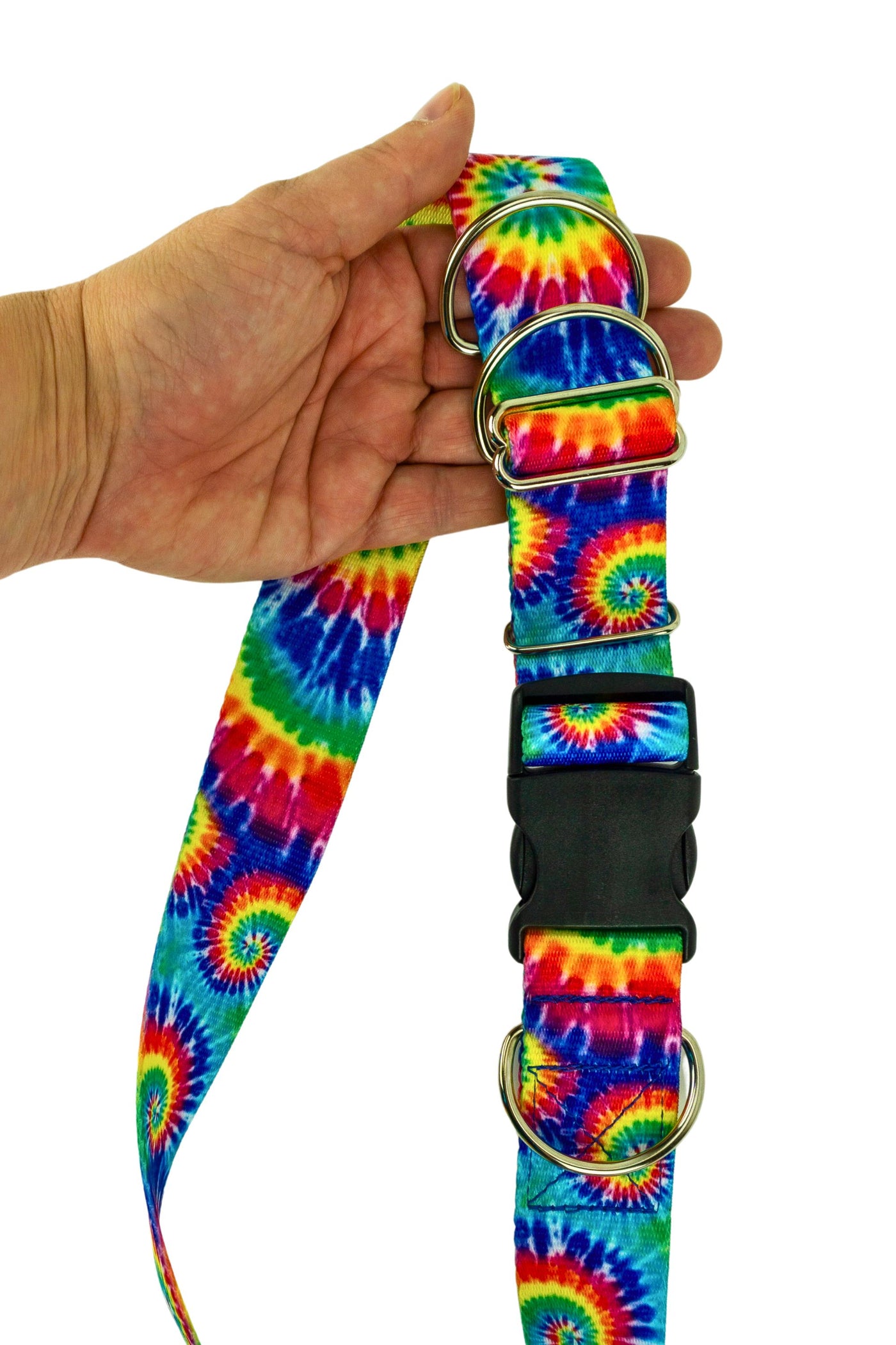 Medium weight hands free leash belt held in the hand of an adult to show the scale of the belt hardware and the patterned webbing.