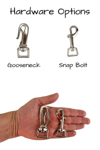 Two hardware options are provided for the training tabs, the gooseneck clip and the snap bolt are shown in the palm of an adult hand for scale.