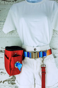 Heavy duty hands free leash belt in the serape patterned webbing, shown on a mannequin with an attached red leash and a red treat pouch with poop bag dispenser.