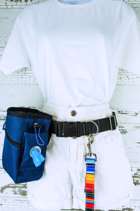 Medium weight hands free leash belt in black webbing, shown on a mannequin with an attached serape patterned leash and a blue treat pouch with poop bag dispenser.