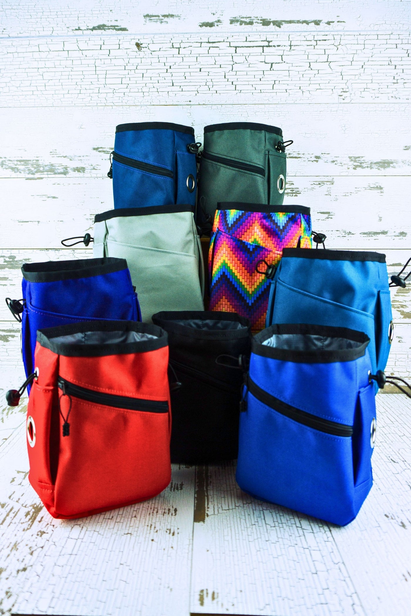 Nine colors of waterproof nylon canvas are available to choose from in this training treat pouch with waste bag dispensers. The colors are black, royal blue, navy blue, red, gray, silver, teal, purple, or a multicolored prism pattern.