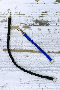 Bungee leash add-on's are shown in a flat lay with a twelve inch segment in blue and a 24 inch segment in black.