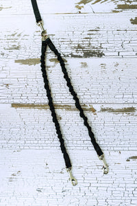 Bungee leash coupler shown in a flat lay in a black webbing.