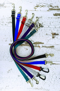 Adjustable length hands free leashes for medium to large dogs shown here in six colors and various hardware options in a flat, swirl lay.