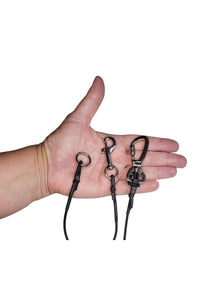 Extra small dog hardware shown in the palm of an adult hand for scale. Choose from a swivel snap bolt or slide lock carabiner and a light weight O ring on the opposite end.