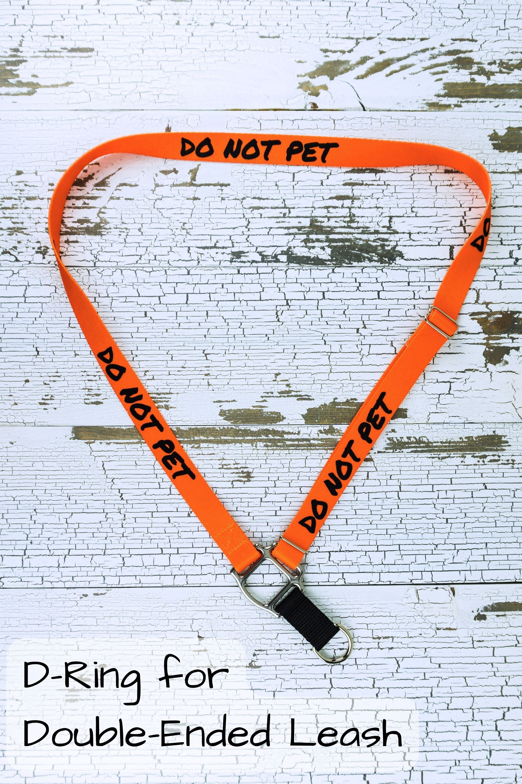 The d ring hardware selection is the correct choice for using with a double clip hands free leash such as those sold in my shop. Shown here in orange with do not pet messaging.