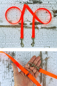 The fixed length leash coupler for small dogs is shown here, with a closeup of the hardware in the palm of an adult hand for scale.