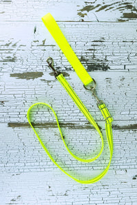 Convert the reflective adjustable length hands free leash for small dogs into a handheld leash by adding a leash handle with a d ring. Shown here in neon yellow reflective leash with a standard (non-reflective) neon yellow leash handle.