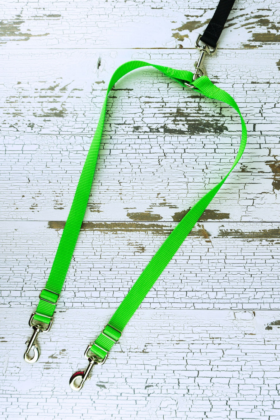Leash coupler for medium to large dogs shown in a flat lay in the neon green color adjustable option.