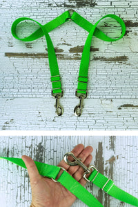 The adjustable length leash coupler is shown here in a closeup of the hardware in the palm of an adult hand for scale.