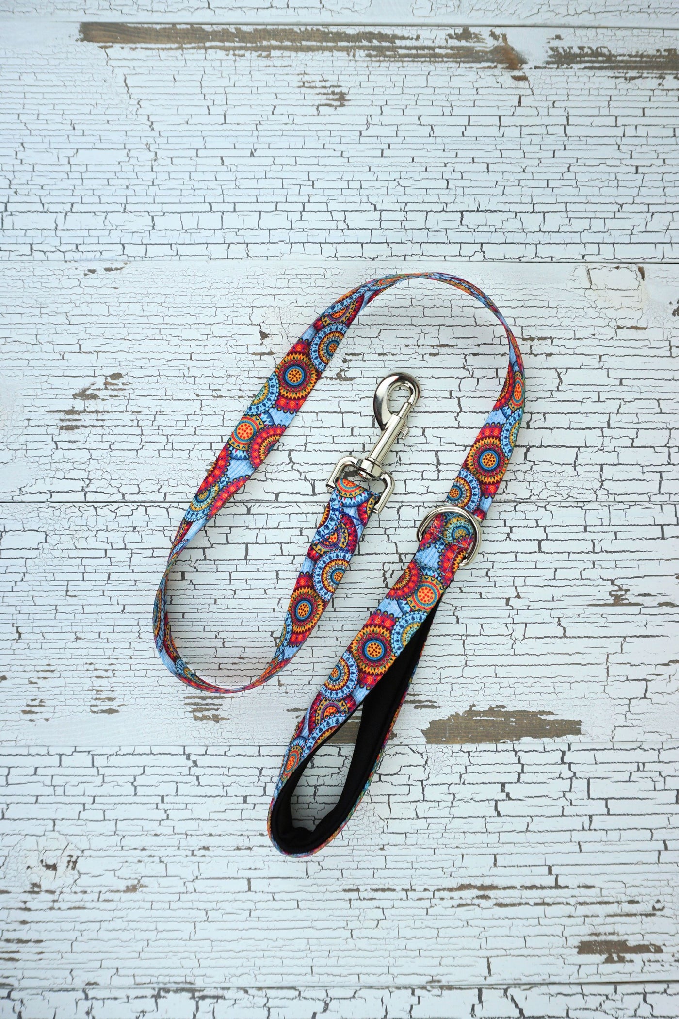 patterned handheld leash in sky mandala with black neonprene padded loop handle.