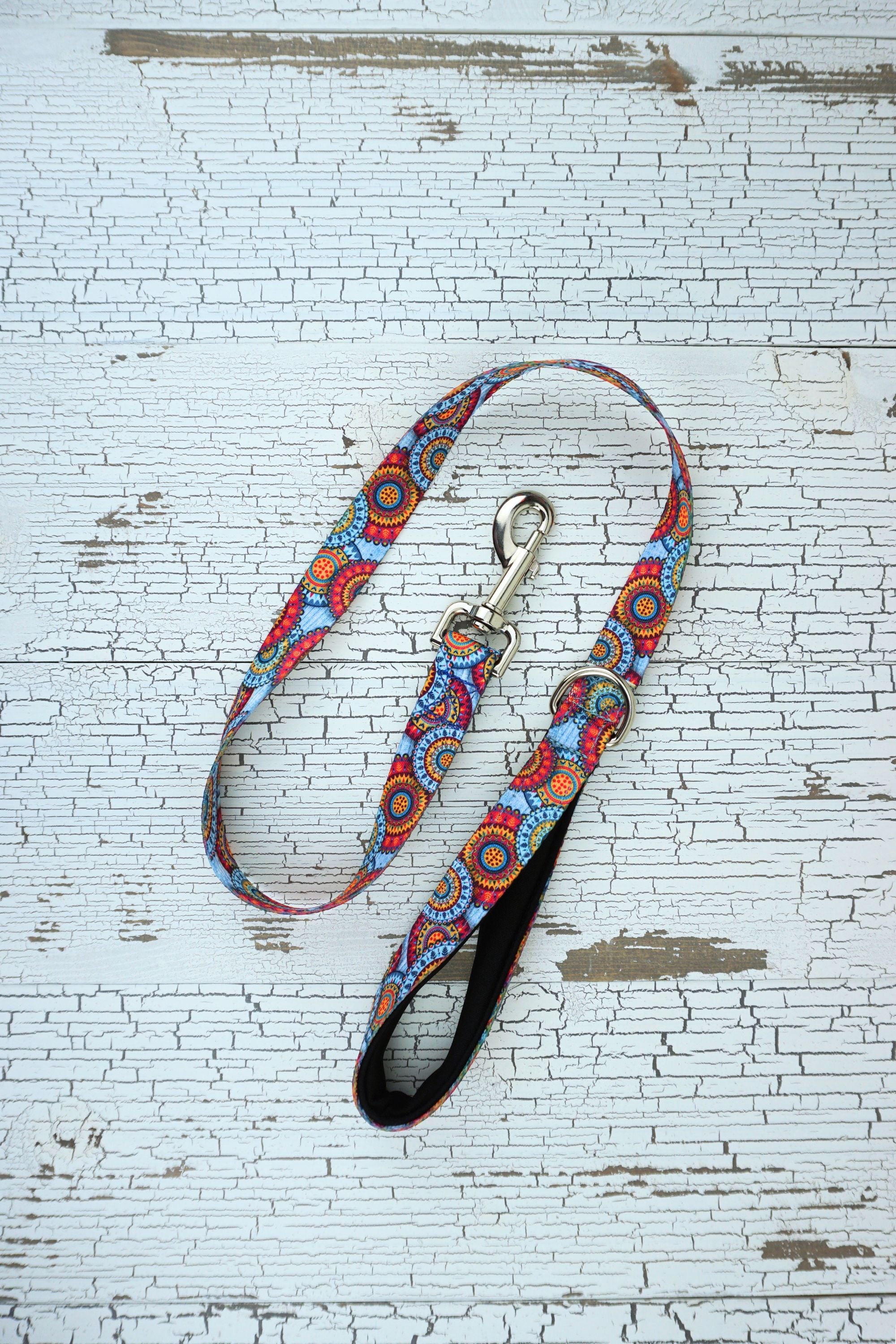 patterned handheld leash in sky mandala with black neonprene padded loop handle.