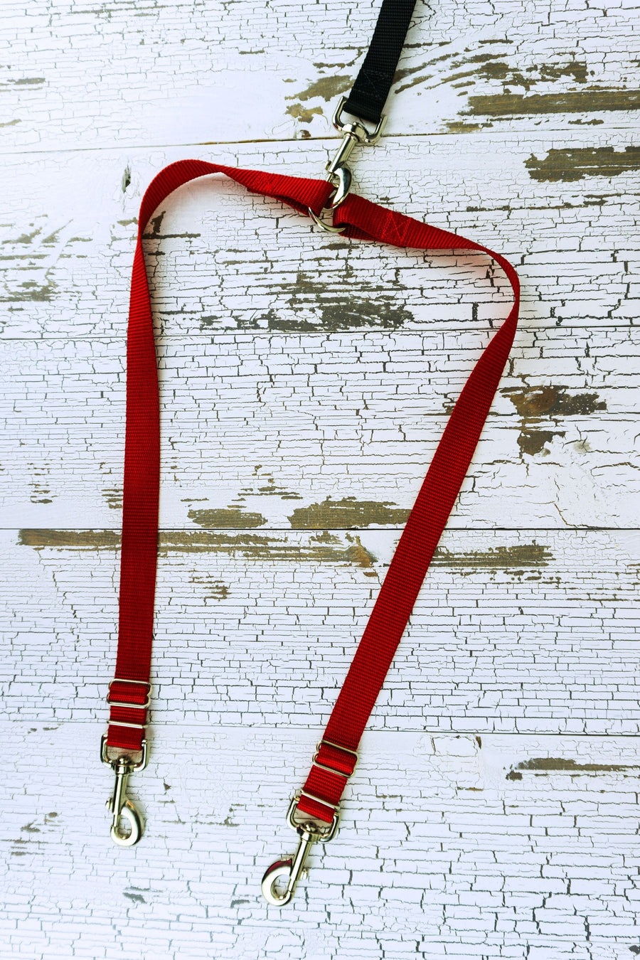 Leash coupler for medium to large dogs shown in a flat lay in the red color adjustable option.