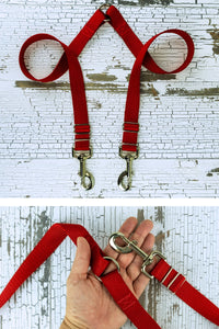 The adjustable length leash coupler is shown here in a closeup of the hardware in the palm of an adult hand for scale.