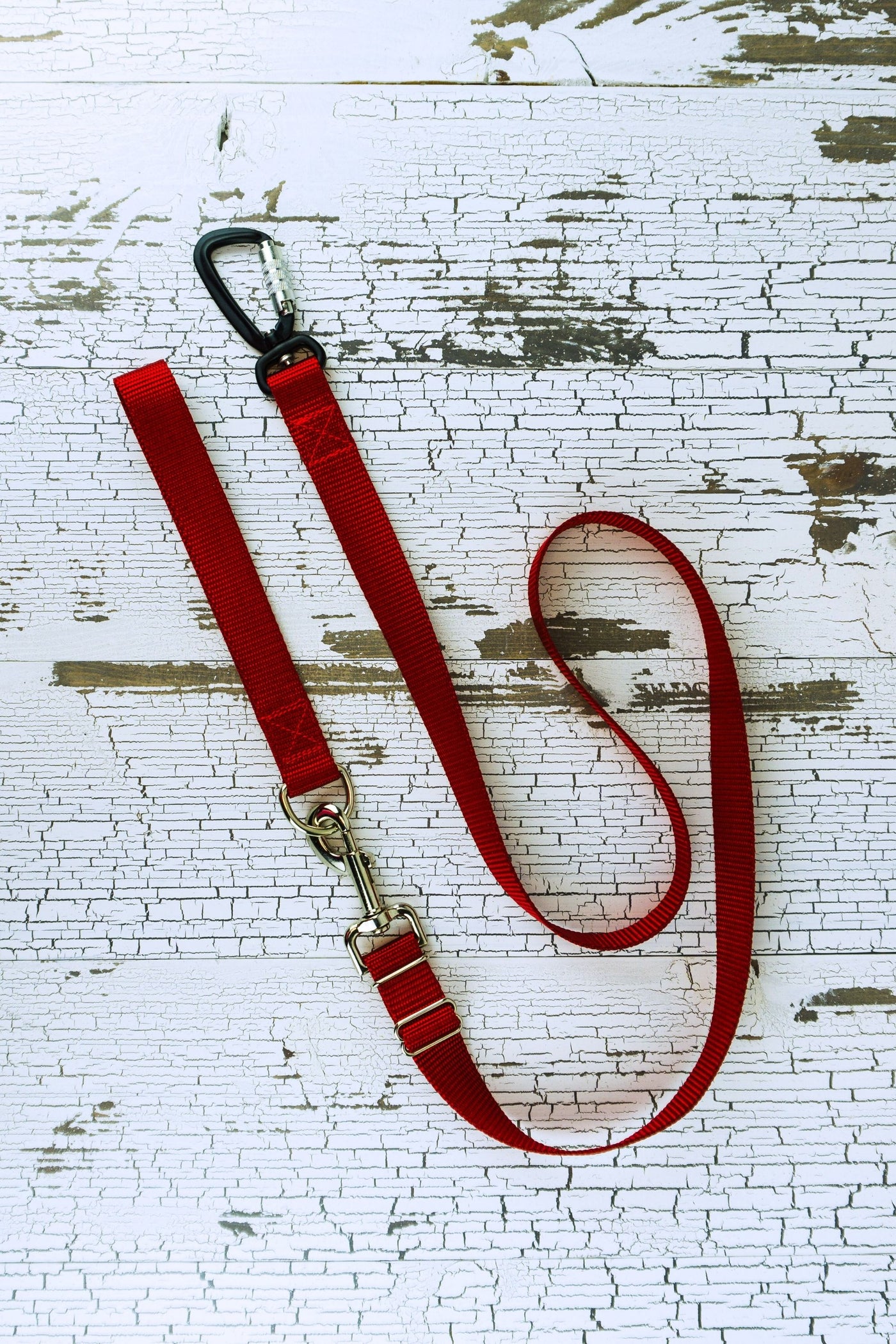 Adjustable length hands free leash shown here in red, converted to a handheld leash by the addition of a leash handle with a d ring.