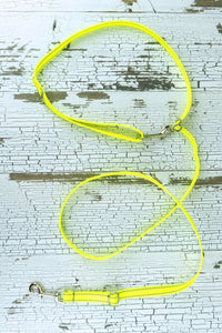 Three way adjustable and convertible leash for small dogs is shown in a flat lay with the waist belt configuration, made in a reflective neon yellow webbing.