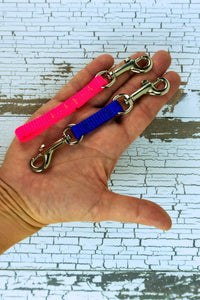 Extra small safety straps are shown in the 5 inch length in the palm of an adult hand for scale.