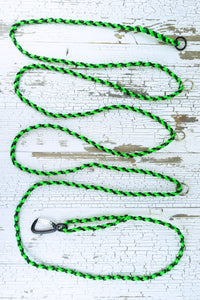 15 foot adjustable long line in braided neon green and black paracord showing 4 o rings and an auto locking carabiner.