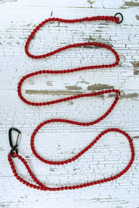 ten foot adjustable long line shown in red blend, leash is laying flat with three o rings and an auto locking carabiner.